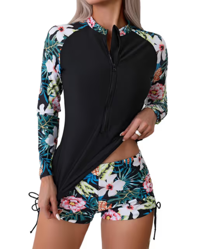 Woman in black floral rashguard surf suit wetsuit
