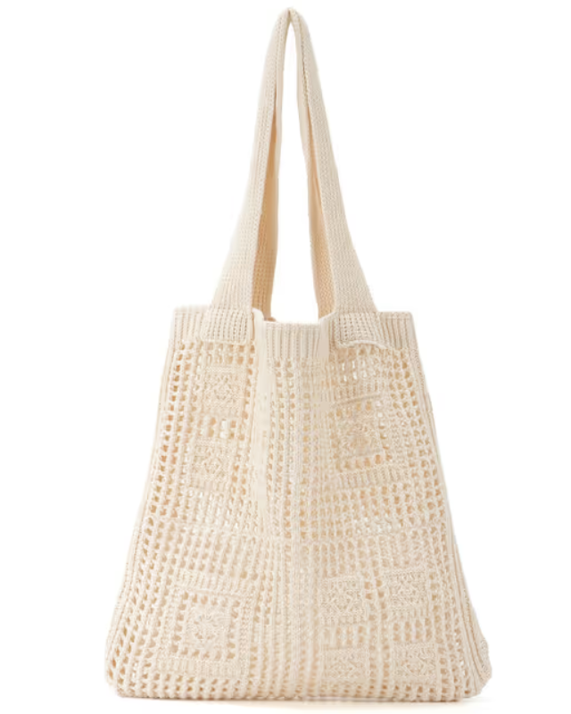 Beige woven tote bag on a white background