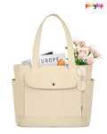 Beige tote bag with flowers, sunglasses, and a newspaper on a white background