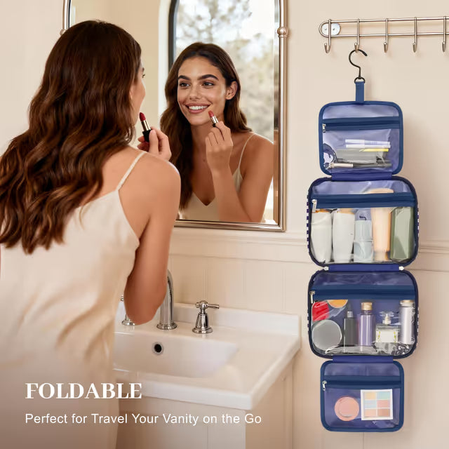 Woman applying makeup in front of a mirror with a blue foldable travel vanity organizer.