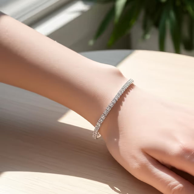 Silver bracelet on a person's wrist with a blurred background