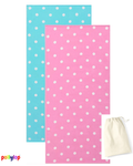 Pink and blue polka dot beach towels on white background
