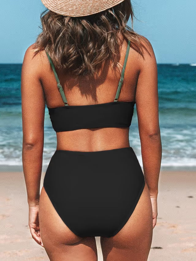 Woman wearing a black twist front high waist bikini on a beach