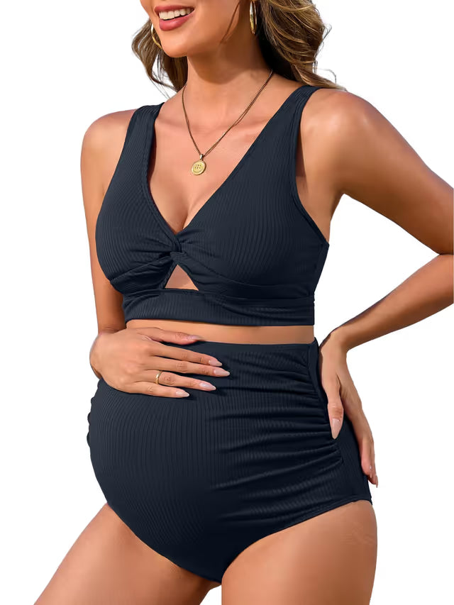 Woman wearing a black two-piece swimsuit on a white background