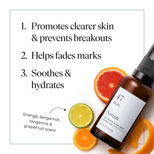 Skincare serum bottle with citrus fruits on a white background