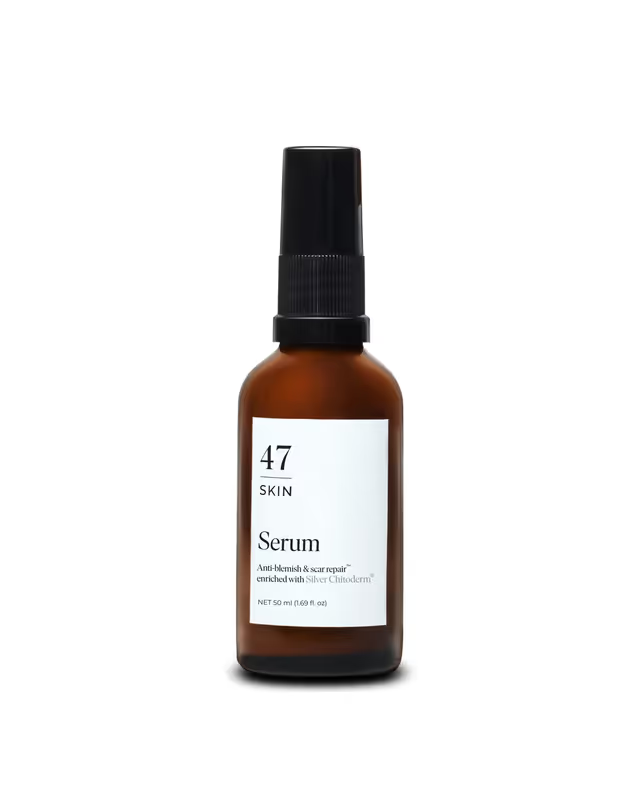 Brown serum bottle with black cap on a white background