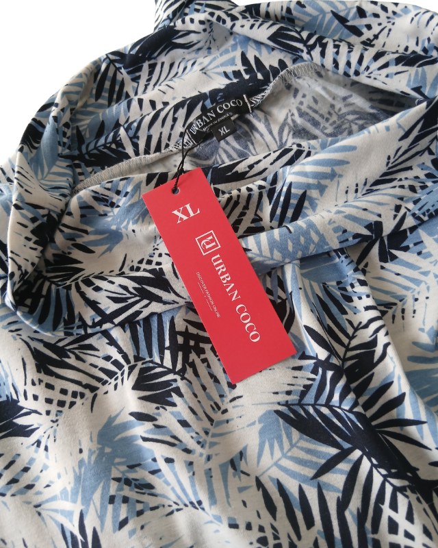 Close-up of a patterned fabric with a Urban Coco tag indicating size XL.