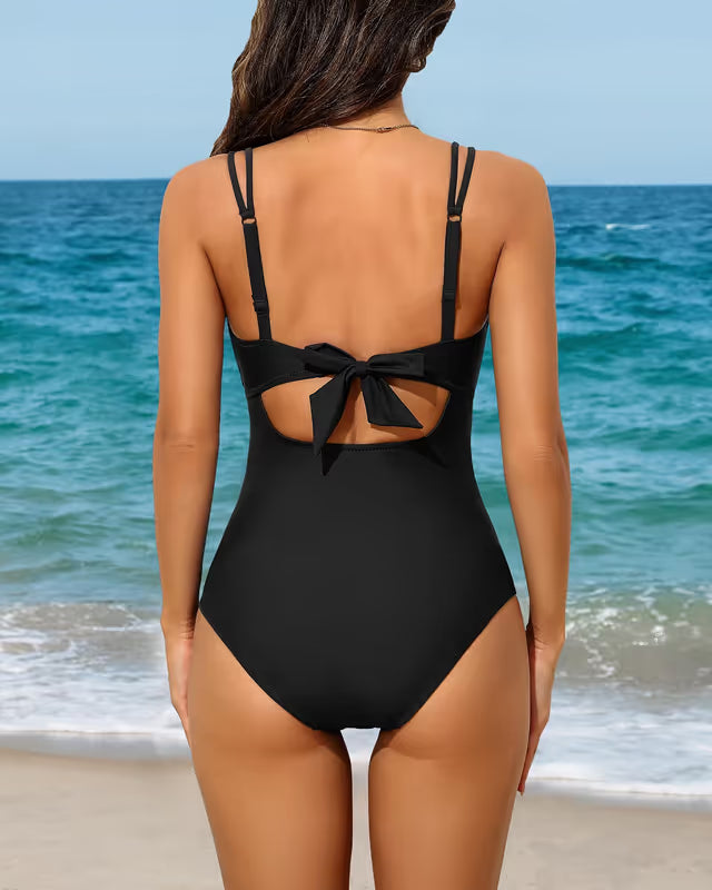 Woman wearing Charmo maternity swim-suit black on a beach back-ground