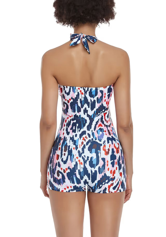 Woman wearing a colourful patterned maternity swim-suit on a white background