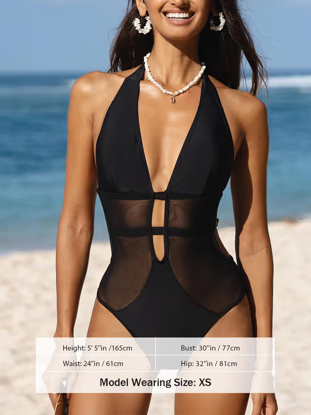 Woman wearing black swimsuit on beach background