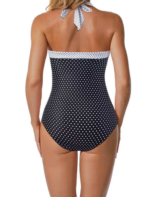 Black polka dot swimsuit with white trim on a white background