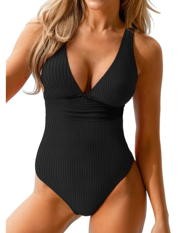 Black ribbed swimsuit worn by a model on a white background
