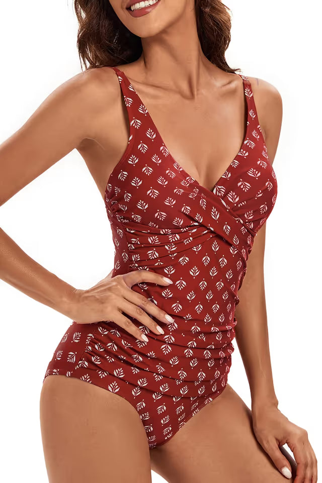 Woman wearing a red patterned swimsuit on a white background