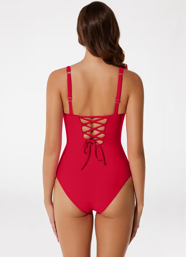 Woman wearing a red swim-suit on a white background