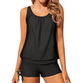 Woman wearing a black tankini on a white background