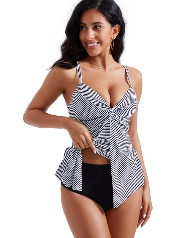 Woman wearing a black and white striped swimsuit on a white background