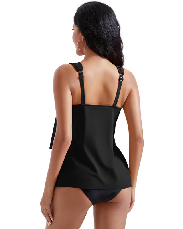 Woman wearing a black tankini set on a white background