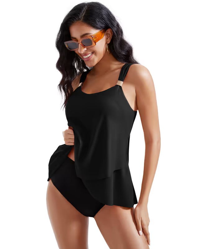 Woman wearing a black swimsuit and sunglasses on a white background