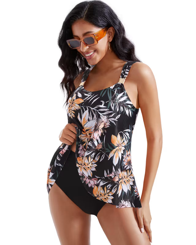 Woman wearing a black floral swimsuit on a white background